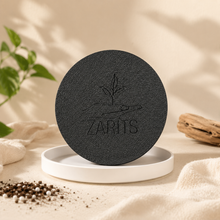 Load image into Gallery viewer, Soucoupe Zarits, disque circulaire noir avec logo Zarits en relief, sur base blanche
