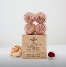 Load image into Gallery viewer, Boules de bain ZARITS orange foncé posées sur une boîte en carton
